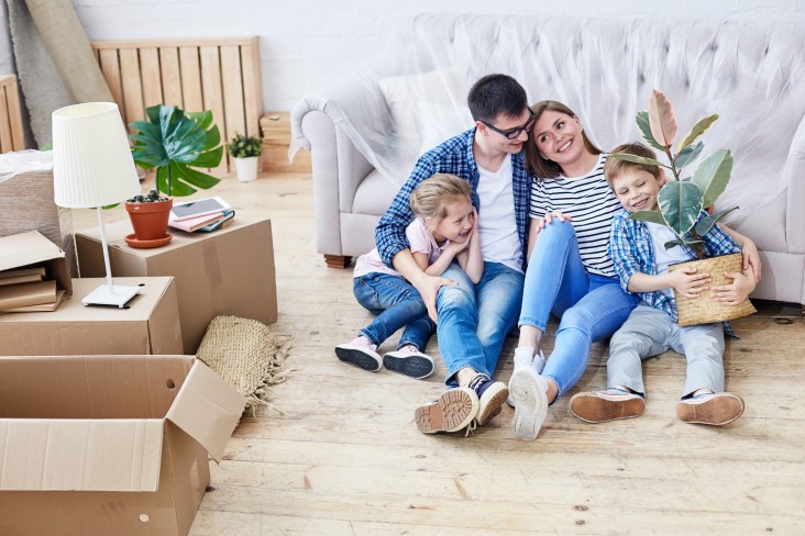 Family sitting on floor of their home