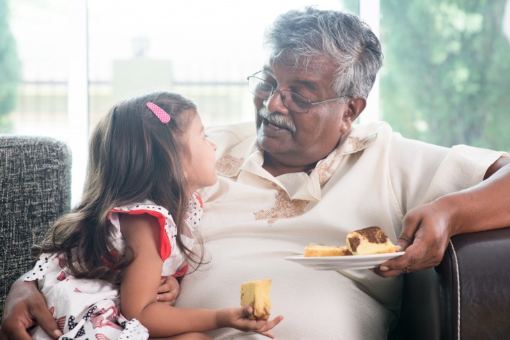 Man shares cake with child