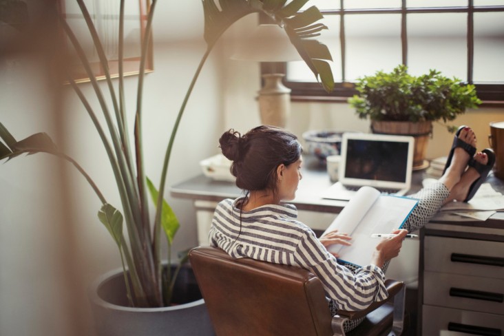 Woman reads notes at desk