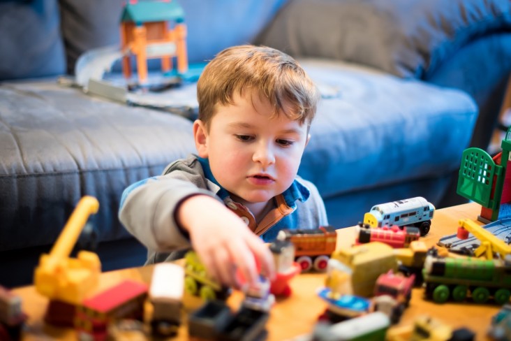 Boy plays with toys by himself