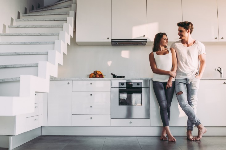 Couple standing in kitchen