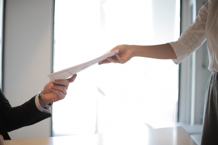 People hand over document