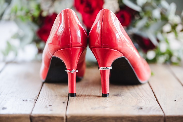 Red shoes with wedding rings