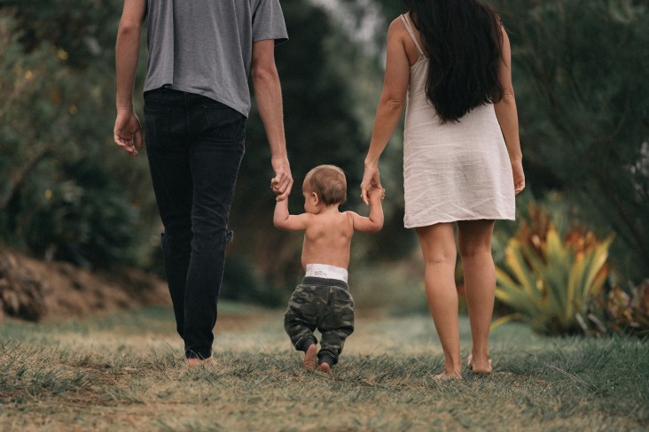 Couple holding hands with a toddler